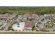 Aerial view of West Lucaya Village Resort community, featuring townhouses, pool, and lush landscaping at 8984 Silver Pl, Kissimmee, FL 34747