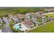 Aerial view showing a community of townhouses near a resort-style pool at West Lucaya at 8984 Silver Pl, Kissimmee, FL 34747