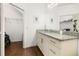 Bathroom with granite countertop, Mickey Mouse pictures, and walk-in closet at 8984 Silver Pl, Kissimmee, FL 34747