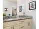 Double vanity bathroom with granite countertop and Disney decor at 8984 Silver Pl, Kissimmee, FL 34747
