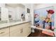 Bathroom with granite countertop, Toy Story shower curtain, and wood-look flooring at 8984 Silver Pl, Kissimmee, FL 34747