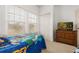 Bedroom with twin beds, dresser, and large window with blinds at 8984 Silver Pl, Kissimmee, FL 34747