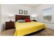 King-size bedroom with yellow bedding and wood furniture at 8984 Silver Pl, Kissimmee, FL 34747