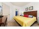 King-size bedroom with yellow bedding and en-suite bathroom at 8984 Silver Pl, Kissimmee, FL 34747
