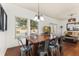 Bright dining area features a wood table with metal chairs, and plenty of natural light at 8984 Silver Pl, Kissimmee, FL 34747