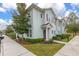 Side view of a light-blue townhome with landscaping and sidewalk at 8984 Silver Pl, Kissimmee, FL 34747
