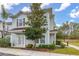 Another view of a light-blue townhome with a tree and walkway at 8984 Silver Pl, Kissimmee, FL 34747