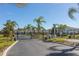 Gated entrance to a community with palm trees and well-maintained landscaping at 8984 Silver Pl, Kissimmee, FL 34747