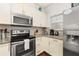 Modern kitchen with stainless steel appliances and granite countertops at 8984 Silver Pl, Kissimmee, FL 34747