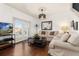 Relaxing living room with beige couch, coffee table, and access to a patio at 8984 Silver Pl, Kissimmee, FL 34747
