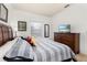 Main bedroom with king-size bed, dresser, and a flat-screen TV at 8984 Silver Pl, Kissimmee, FL 34747