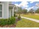 Side yard of townhome with landscaping and a walkway at 8984 Silver Pl, Kissimmee, FL 34747