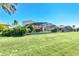 Spacious backyard with a screened-in pool and lush green lawn at 1020 Golf Course Pkwy, Davenport, FL 33837