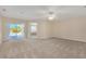 Primary bedroom with patio access and ensuite bath at 1020 Golf Course Pkwy, Davenport, FL 33837