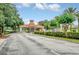 Gated community entrance with a guard house and lush landscaping at 1020 Golf Course Pkwy, Davenport, FL 33837