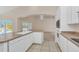 Kitchen with white cabinets, stainless steel appliances, and island overlooking pool at 1020 Golf Course Pkwy, Davenport, FL 33837