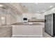 Kitchen with white cabinets, stainless steel appliances, and an island at 1020 Golf Course Pkwy, Davenport, FL 33837