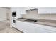 White kitchen cabinets, black cooktop and microwave at 1020 Golf Course Pkwy, Davenport, FL 33837