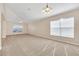 Sunlit living room with vaulted ceiling and carpeting at 1020 Golf Course Pkwy, Davenport, FL 33837