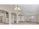Open living room with vaulted ceiling and access to the backyard at 1020 Golf Course Pkwy, Davenport, FL 33837