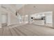 Two-story living room with high ceilings, staircase, and kitchen at 1020 Golf Course Pkwy, Davenport, FL 33837