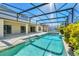 Refreshing pool with screened patio and lush landscaping at 1020 Golf Course Pkwy, Davenport, FL 33837
