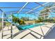 Screened pool and spa with a slide and ladder access at 1020 Golf Course Pkwy, Davenport, FL 33837