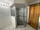Modern bathroom with a large walk-in shower and marble tile at 104 Crescent Ct, Kissimmee, FL 34758
