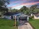 Newly renovated home with a carport and well-manicured lawn at 1234 Lynwood Ave, Apopka, FL 32703