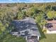 Aerial view of a single-story home with a dark roof, carport, and green lawn at 1234 Lynwood Ave, Apopka, FL 32703