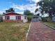 Single-story home with red shutters, brick accents, and a large front yard at 1427 Wilton Ave, Orlando, FL 32805