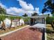 Front view of a single-story home with a covered carport and brick driveway at 1427 Wilton Ave, Orlando, FL 32805