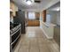 Kitchen with stainless steel appliances, wood cabinetry, and tile flooring at 1427 Wilton Ave, Orlando, FL 32805
