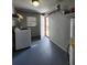 Laundry room with washer, dryer, and storage shelves at 1427 Wilton Ave, Orlando, FL 32805