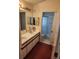 Dual vanity bathroom with walk-in shower and tiled floors at 2528 Chatham Cir, Kissimmee, FL 34746