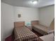 Bedroom with two twin beds, nightstand, and red carpet at 2528 Chatham Cir, Kissimmee, FL 34746