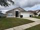 Charming single-story home with a well-maintained lawn and attached garage at 2528 Chatham Cir, Kissimmee, FL 34746