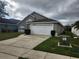 Exterior view of a one-story home with an attached garage and driveway at 2528 Chatham Cir, Kissimmee, FL 34746