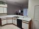 Practical kitchen with ample counter space, dishwasher, and white cabinetry at 2528 Chatham Cir, Kissimmee, FL 34746
