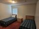 Second Bedroom with two twin beds, a nightstand, and window with blinds at 2528 Chatham Cir, Kissimmee, FL 34746