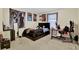 Carpeted bedroom with anime posters, a bed, a desk, and a mirror at 2870 Moonstone Bnd, Kissimmee, FL 34758