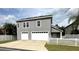 Two-car garage with a driveway and white fence at 3327 Schoolhouse Rd, Harmony, FL 34773