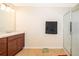 Bathroom featuring a single vanity, glass shower stall, and neutral-toned tile at 3896 Grassland Dr, Orlando, FL 32824