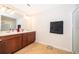 Spacious bathroom with double vanity, large mirror, and walk-in shower at 3896 Grassland Dr, Orlando, FL 32824