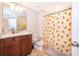 Bathroom with single vanity, toilet, and shower with festive holiday curtain at 3896 Grassland Dr, Orlando, FL 32824