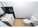 Stylish half bathroom with black and white tile, modern vanity, and gold fixtures at 3896 Grassland Dr, Orlando, FL 32824