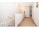 Hallway with a staircase, safety gate, and carpeted floors at 3896 Grassland Dr, Orlando, FL 32824