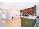 Modern kitchen with dark wood cabinets, stainless steel appliances, and a breakfast bar at 3896 Grassland Dr, Orlando, FL 32824