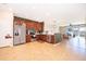 Open-concept kitchen with wood cabinets, stainless steel appliances, and view of the living area at 3896 Grassland Dr, Orlando, FL 32824