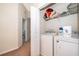 Laundry room with washer and dryer and open shelving at 3896 Grassland Dr, Orlando, FL 32824